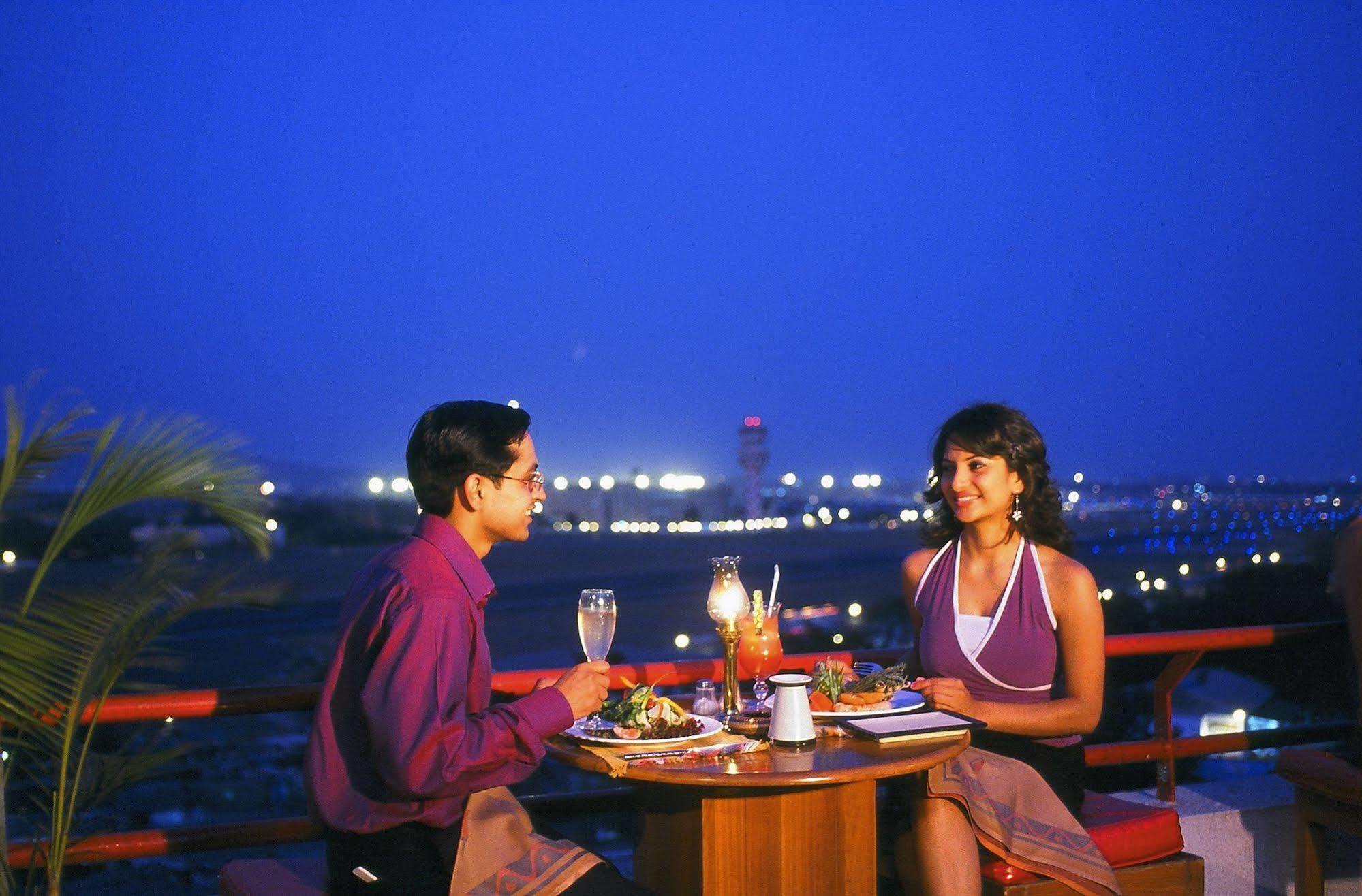 The Orchid Hotel Mumbai Vile Parle מסעדה תמונה A couple dining at a restaurant in India